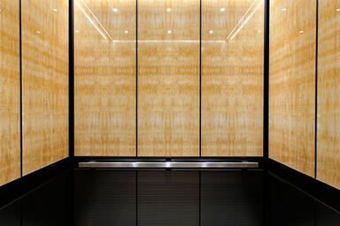 LEVELe-105 Elevator Interior with upper panels in ViviStone Honey Onyx 
